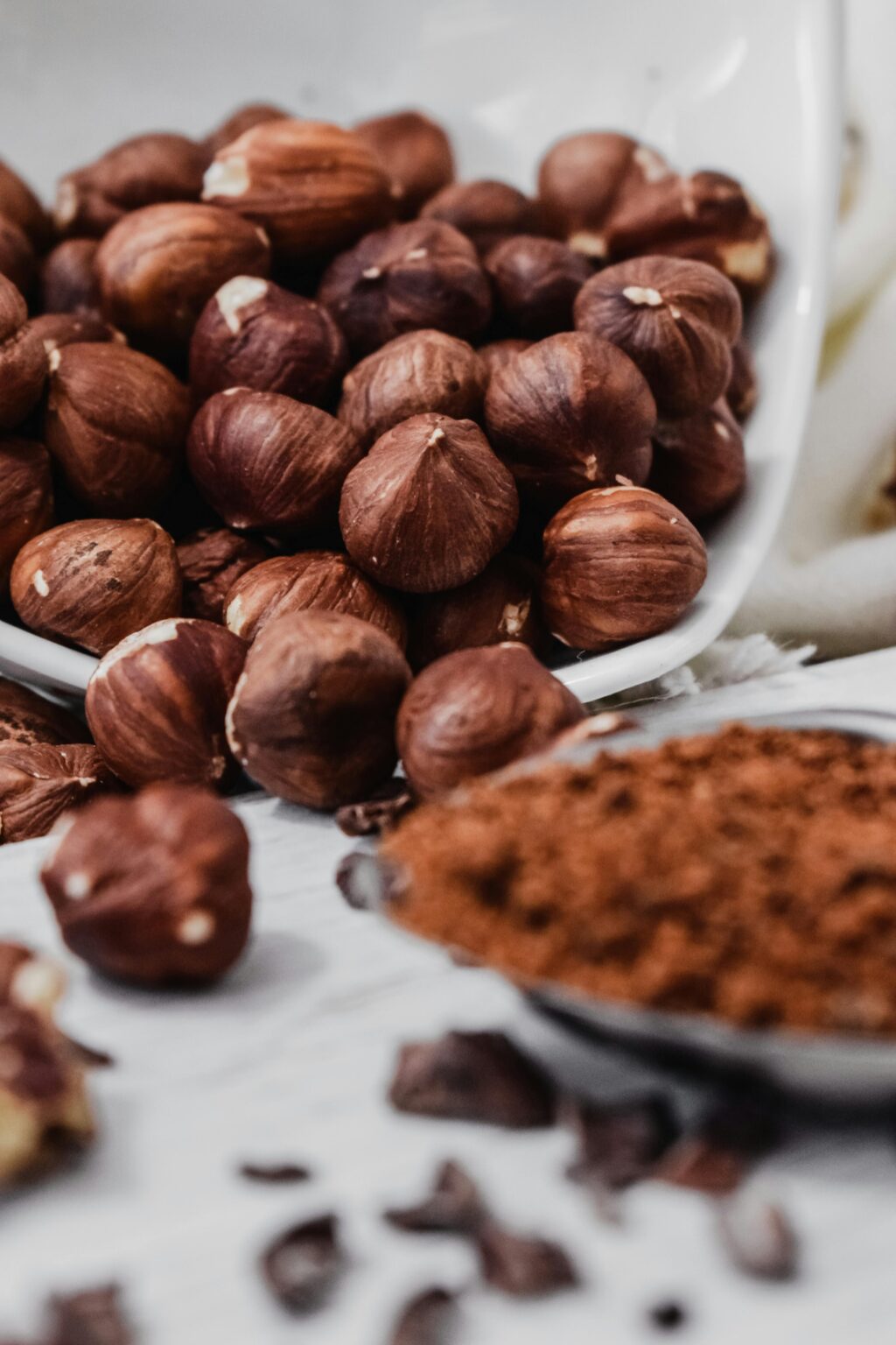 A detailed close-up of roasted hazelnuts and cocoa powder, perfect for culinary uses.